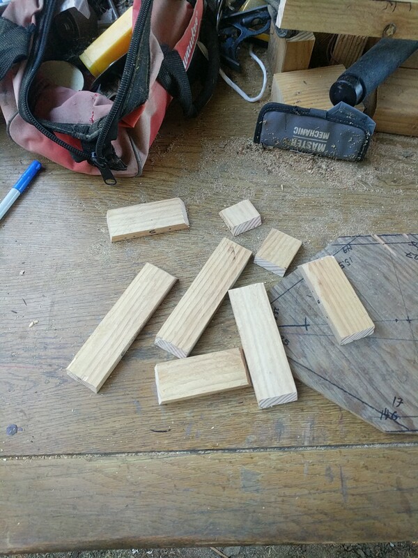 2" wide pieces of ¼ inch wood, scattered on a table