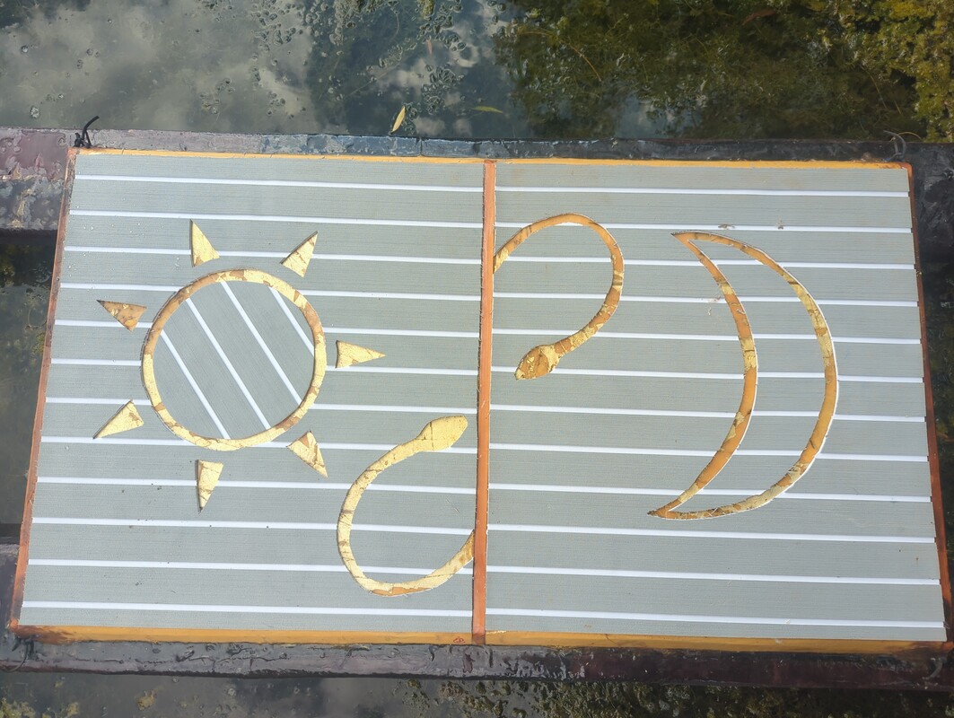 Sun, Moon, and 2 Snake motif cut out of a traction pad