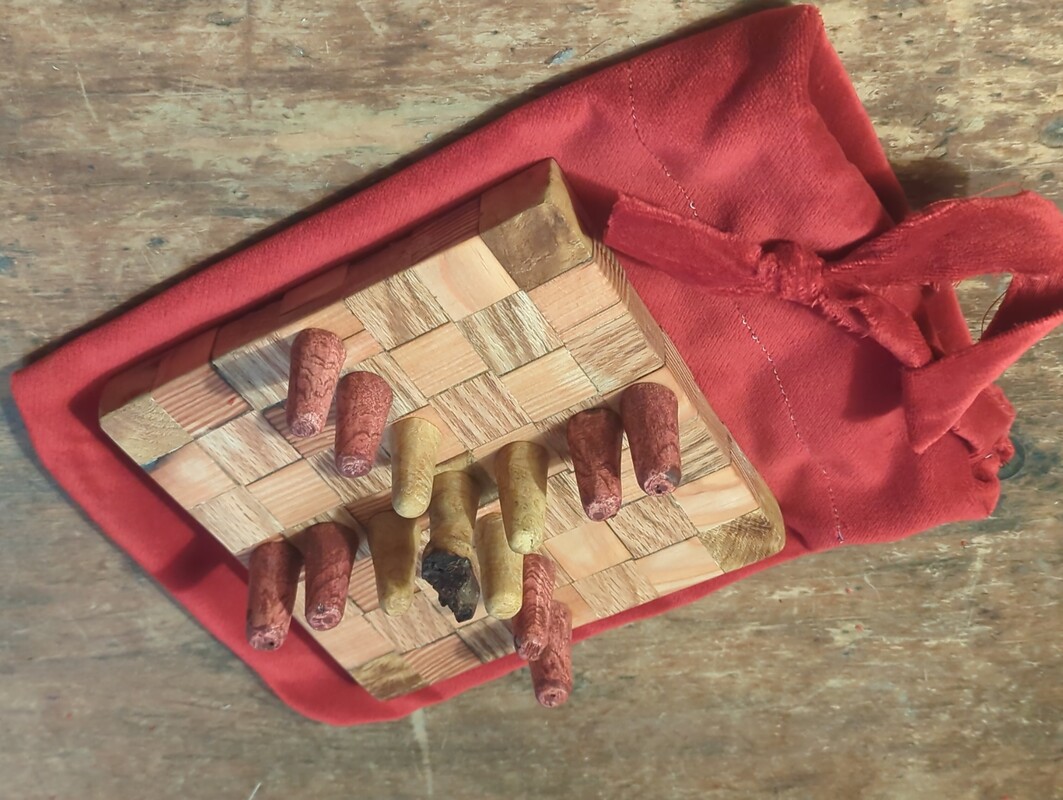 brandubh game pieces, on the board, on the bag