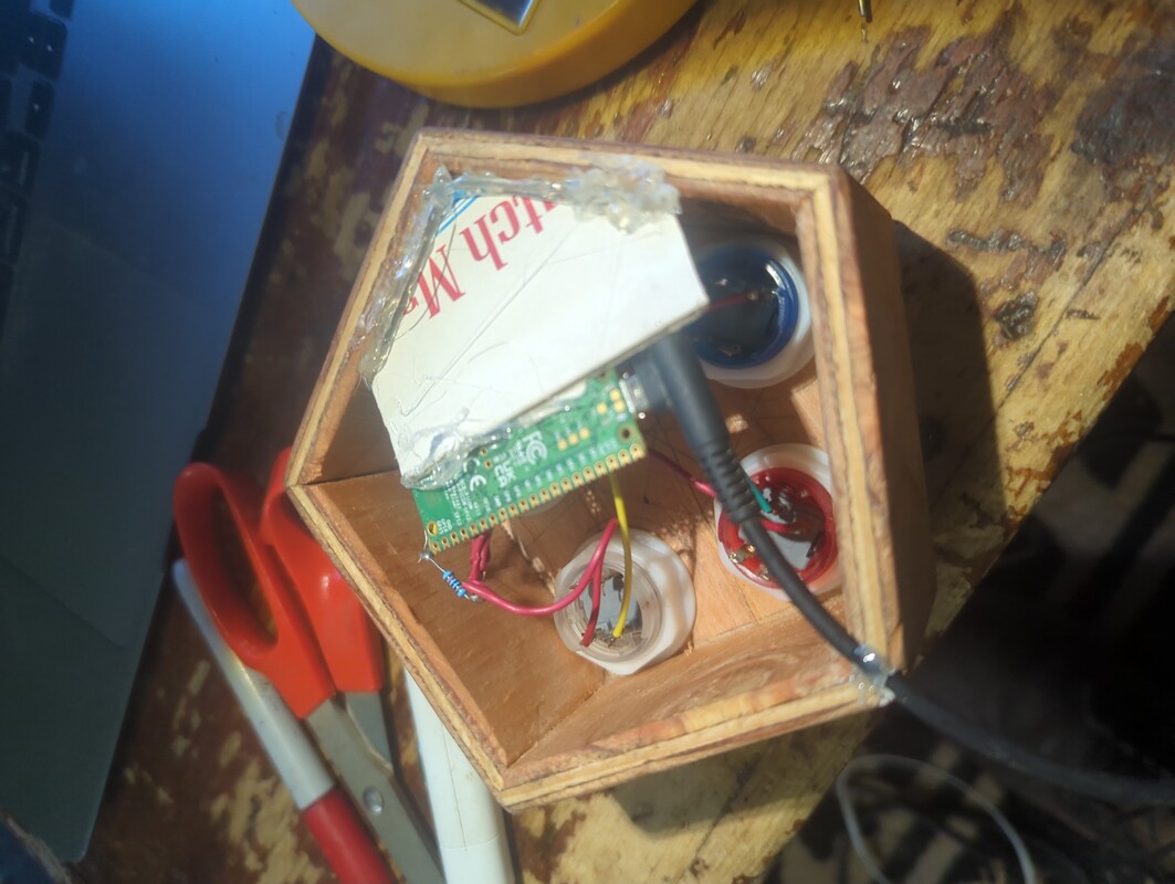 piece of cigar boxed hot glued to corner of case. the pico is glued to the piece of cigar box.