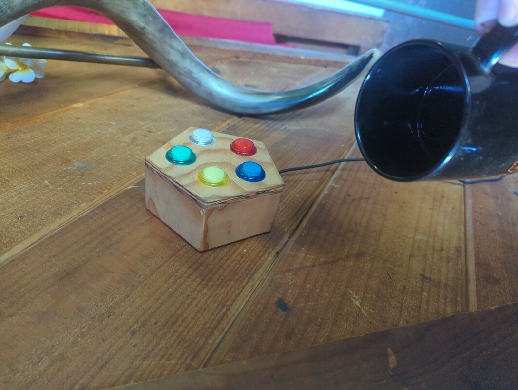 Pentabutton mounted on a wall near a door